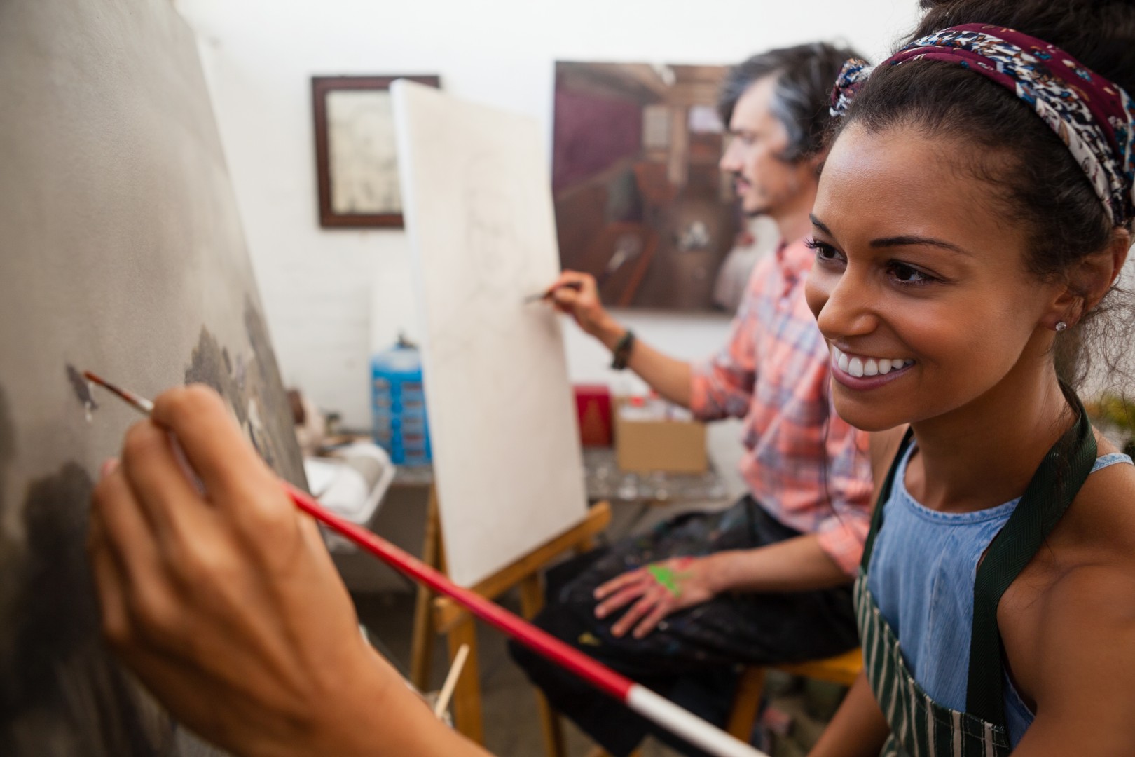 Neighbors painting together in an art class